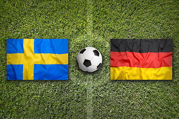 Image showing Sweden vs. Germany flags on soccer field