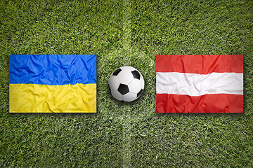 Image showing Ukraine vs. Austria flags on soccer field