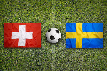 Image showing Switzerland vs. Sweden flags on soccer field