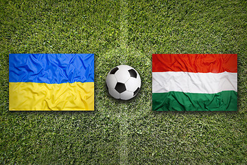 Image showing Ukraine vs. Hungary flags on soccer field