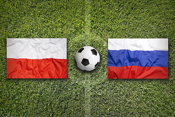 Image showing Poland vs. Russia flags on soccer field