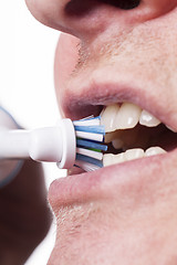 Image showing Close up of electric toothbrush and paste on white