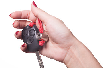 Image showing Close up of hand holding car key on white