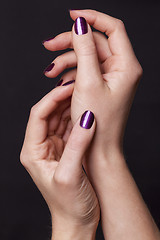 Image showing Close up of female hands over black