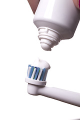 Image showing Close up of electric toothbrush and paste on white