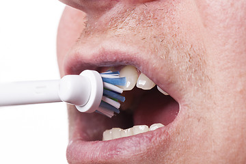 Image showing Close up of electric toothbrush and paste on white