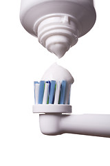 Image showing Close up of electric toothbrush and paste on white