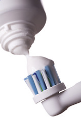 Image showing Close up of electric toothbrush and paste on white