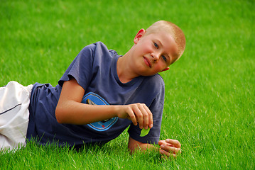 Image showing young boy is resting on the grass