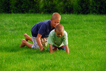 Image showing two boys play on the grass