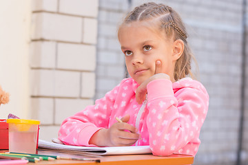 Image showing Schoolgirl thought drawing on the album in pencil, in the yard