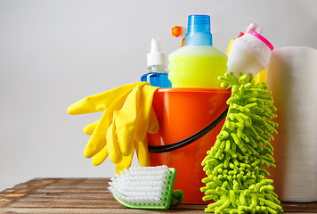 Image showing Bucket with cleaning items on light background