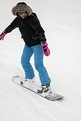 Image showing Woman doing exercise on snowboard