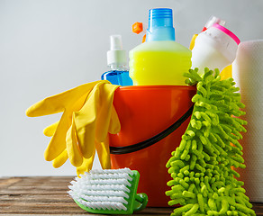 Image showing Bucket with cleaning items on light background