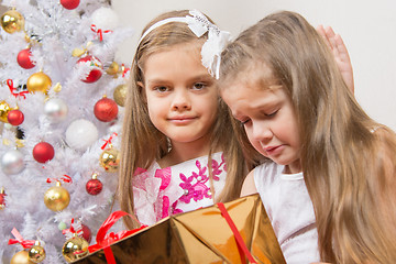 Image showing The girl gave the wrong gift, another girl comforting her