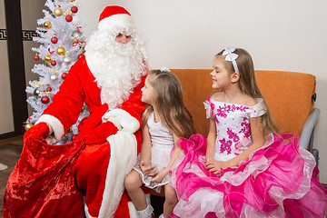 Image showing The girls looked at the bag drop frost grandfather waiting for gifts