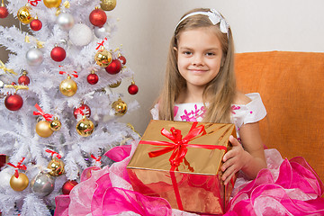 Image showing girl in a beautiful dress gave New Year gift