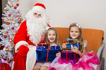 Image showing Santa Claus gave presents to the children, and together looked in the frame