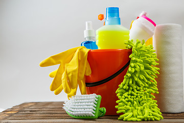 Image showing Bucket with cleaning items on light background