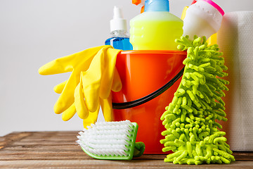 Image showing Bucket with cleaning items on light background