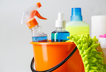 Image showing Bucket with cleaning items on light background