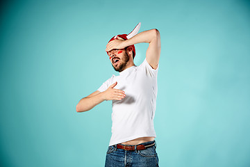 Image showing The face of football fan with different emotions on blue