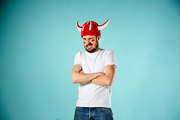 Image showing The face of football fan with different emotions on blue