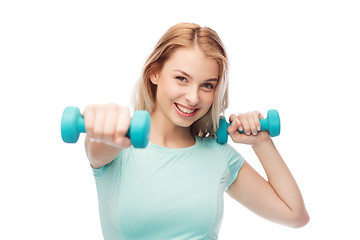 Image showing smiling beautiful young sporty woman with dumbbell