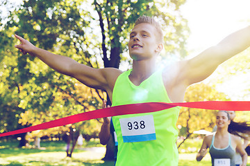 Image showing happy young male runner winning on race finish