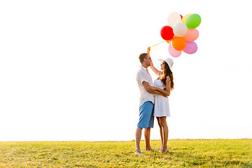 Image showing smiling couple with air balloons outdoors