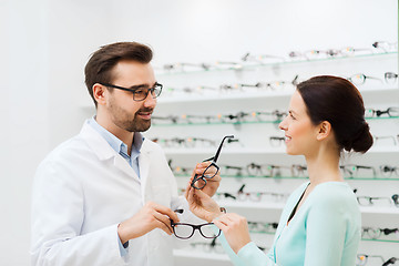 Image showing woman and optician showing glasses at optics store