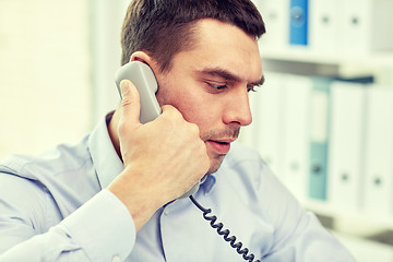 Image showing face of businessman calling on phone in office