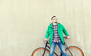 Image showing happy young hipster man with fixed gear bike