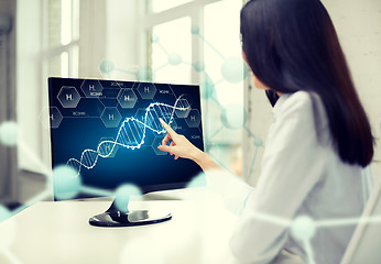 Image showing close up of woman with dna molecule on computer