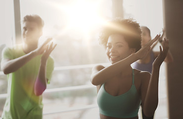 Image showing group of smiling people dancing in gym or studio