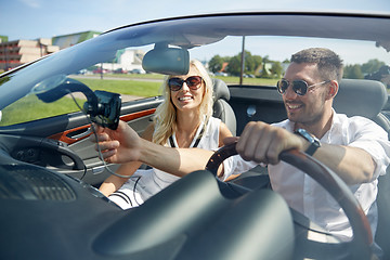 Image showing happy couple using gps navigator in cabriolet car