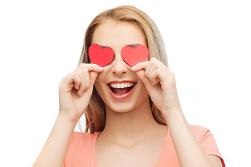 Image showing happy young woman with red heart shapes on eyes