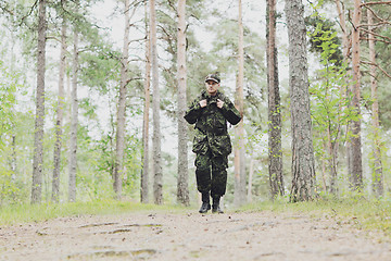 Image showing young soldier with backpack in forest