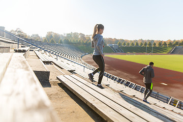 Image showing couple running downstairs on stadium