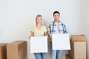 Image showing smiling couple with big boxes moving to new home