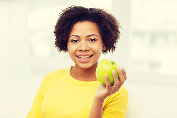 Image showing happy african american woman with green apple