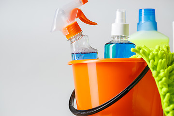 Image showing Bucket with cleaning items on light background