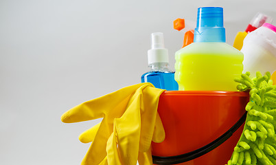 Image showing Bucket with cleaning items on light background