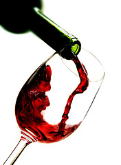 Image showing Red wine pouring into wine glass