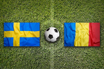 Image showing Sweden vs. Romania flags on soccer field