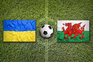 Image showing Ukraine vs. Wales flags on soccer field