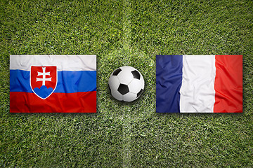 Image showing Slovakia vs. France flags on soccer field