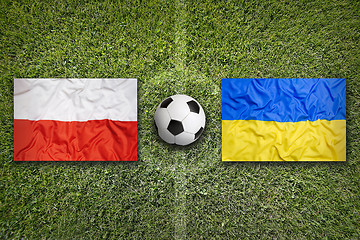 Image showing Poland vs. Ukraine flags on soccer field