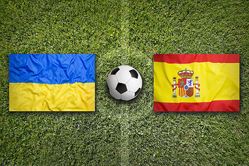 Image showing Ukraine vs. Spain flags on soccer field