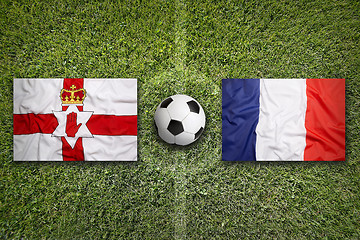 Image showing Northern Ireland vs. France flags on soccer field